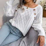 White cable-knit sweater styled with light-wash jeans, chic casual look
